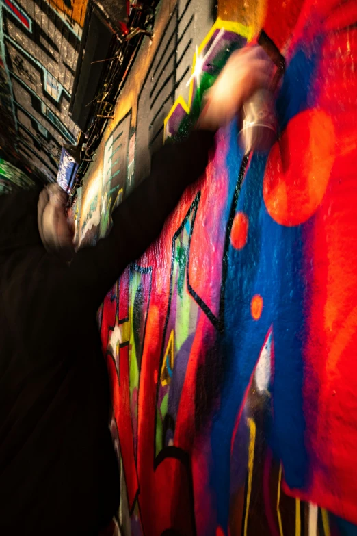 a person in black shirt painting a wall