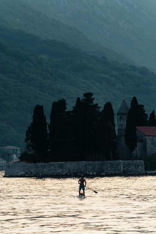 a person with a surfboard in the water