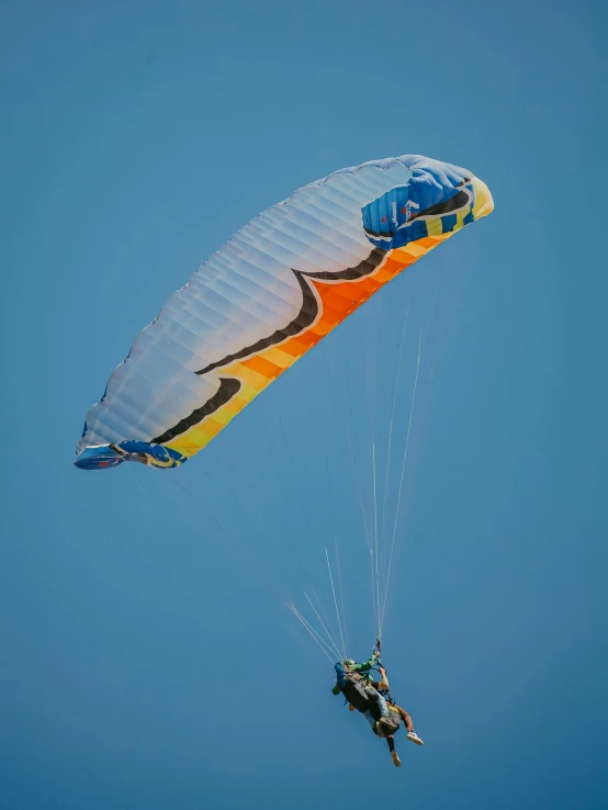 a man riding a parasail during a sunny day