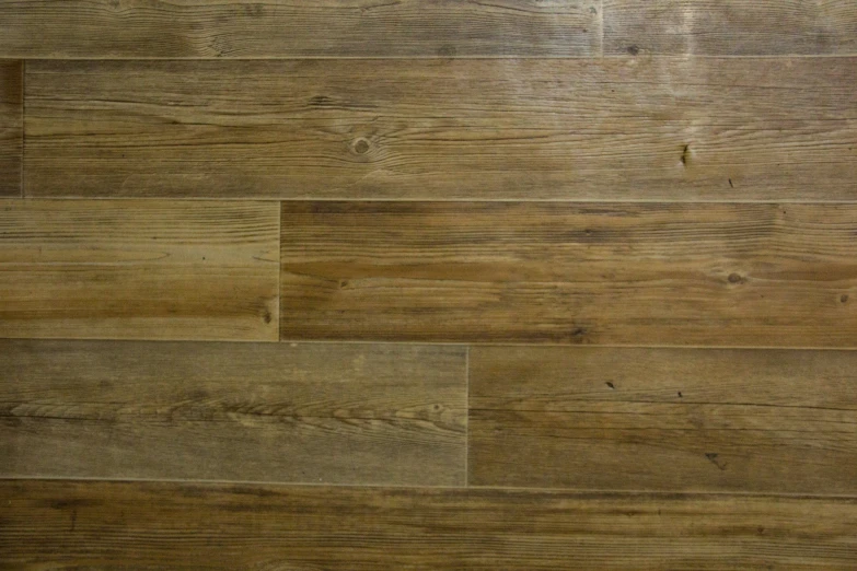 a black cat sitting on top of a wooden floor