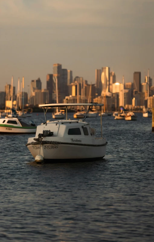 boats traveling on the water near a city