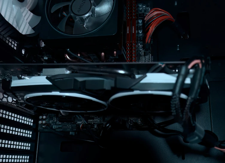 a fan and case are located on a dark computer