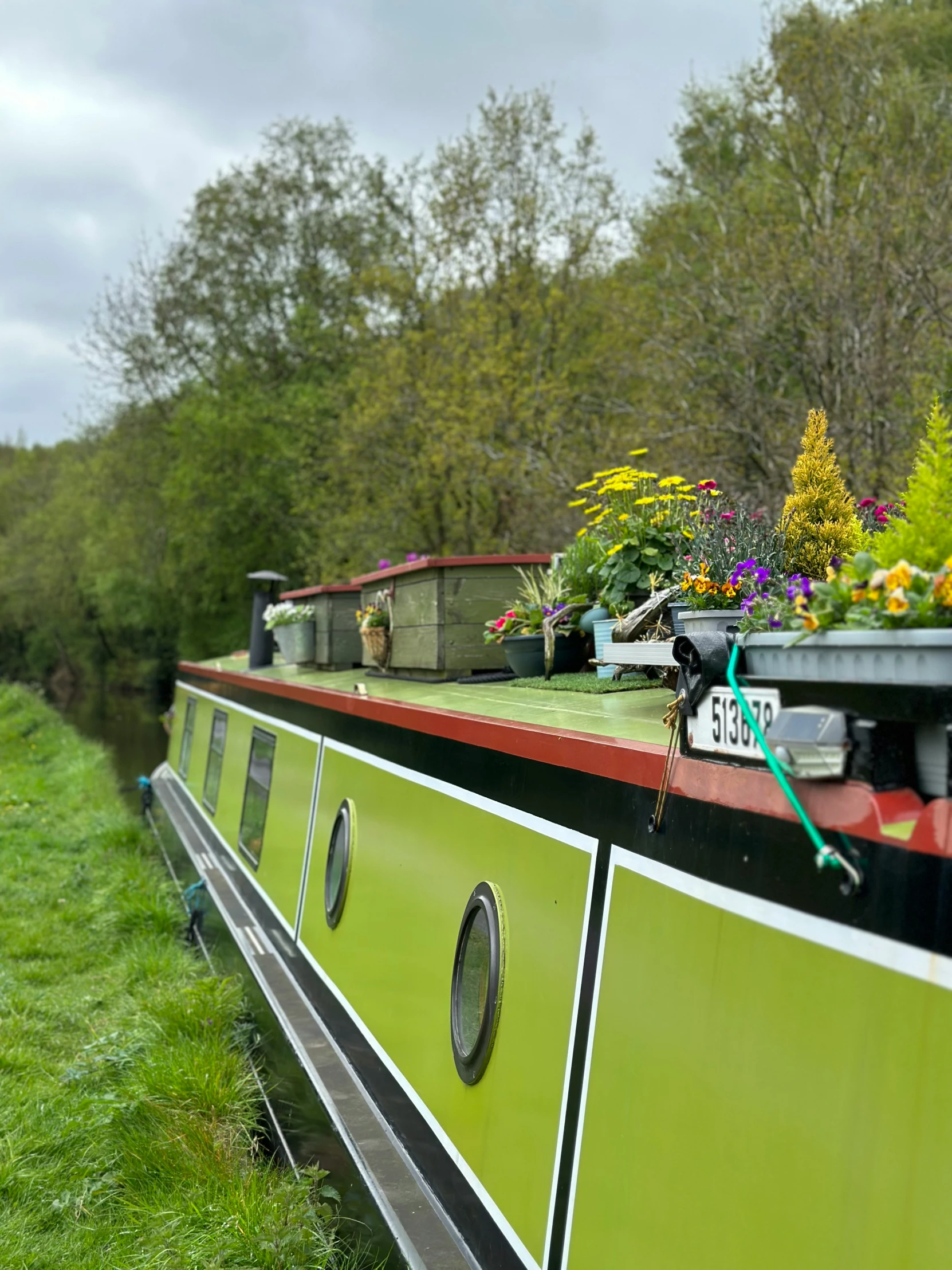 a houseboat is painted black, white and green