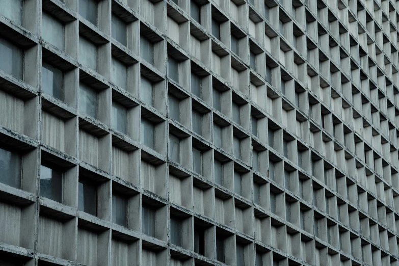 the corner of a brick building with square holes