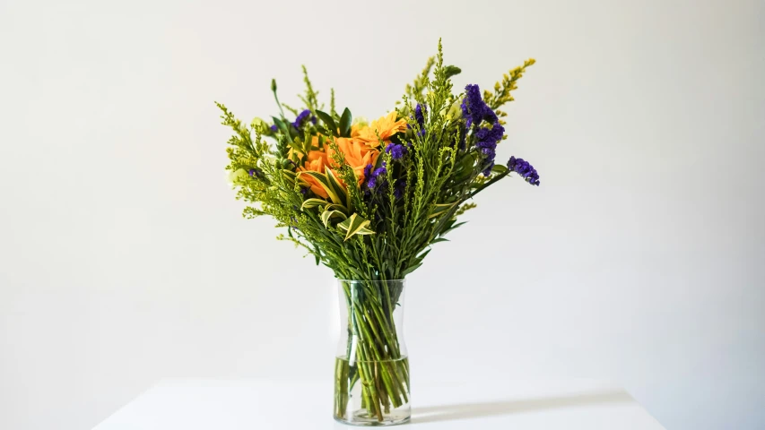 a vase with different types of flowers in it