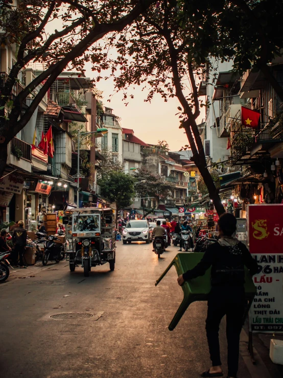 the silhouette of a man holding a sign as he walks down a street