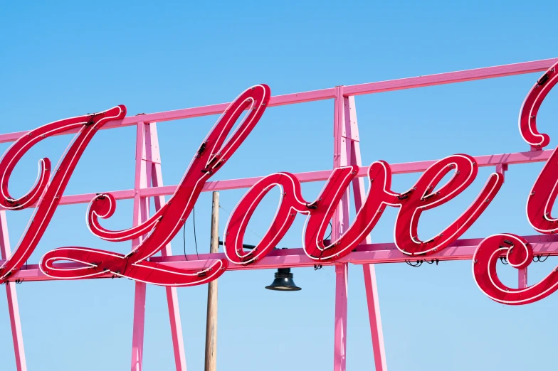 a neon sign that says love with the letters love above it