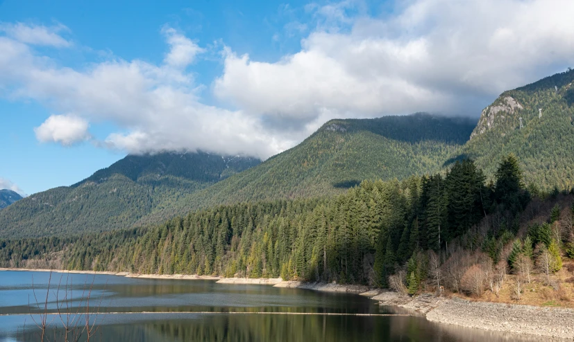 the mountains and water are reflected in the calm waters