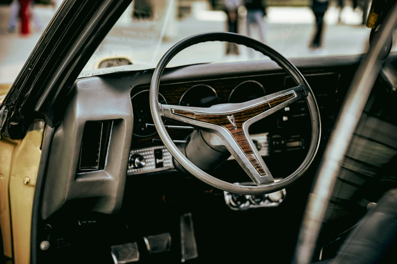 a steering wheel and dashboard in an old car