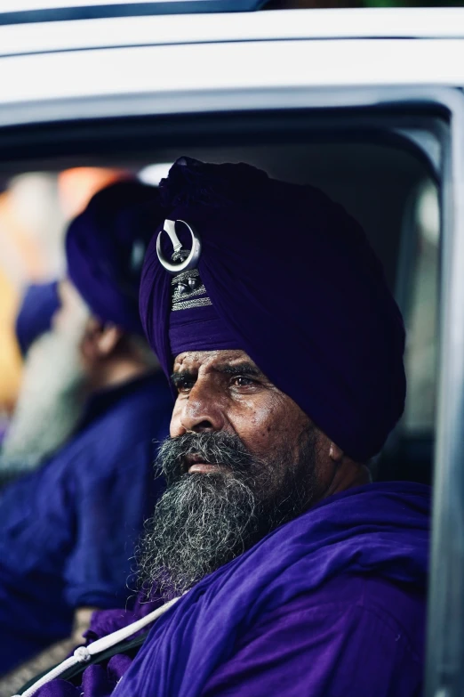 a close up of a man with a beard wearing a turban