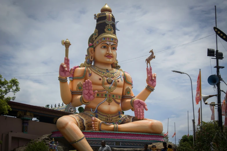 a large statue of a woman sitting in a lotus position