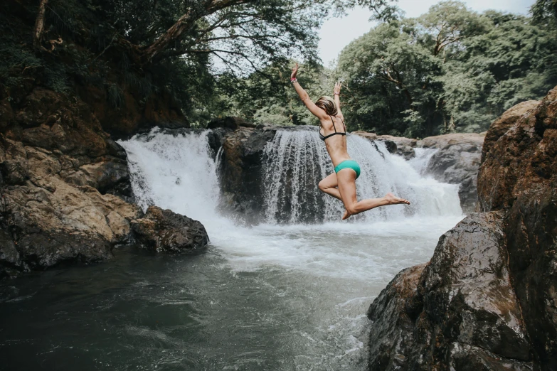 a person jumping into a body of water