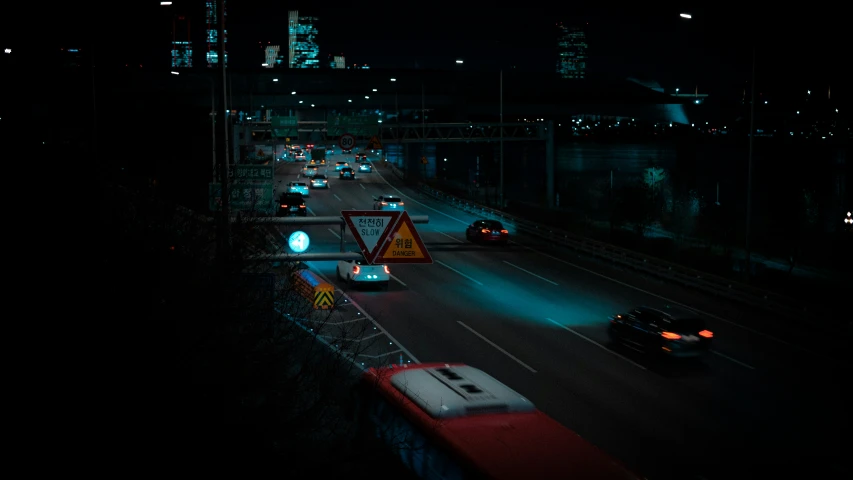 a busy city street has traffic lights at night