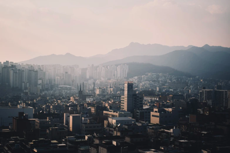 cityscape taken from above with mountain range in background