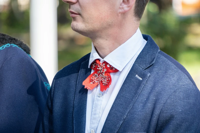 man wearing an unusual red bow tie and suit