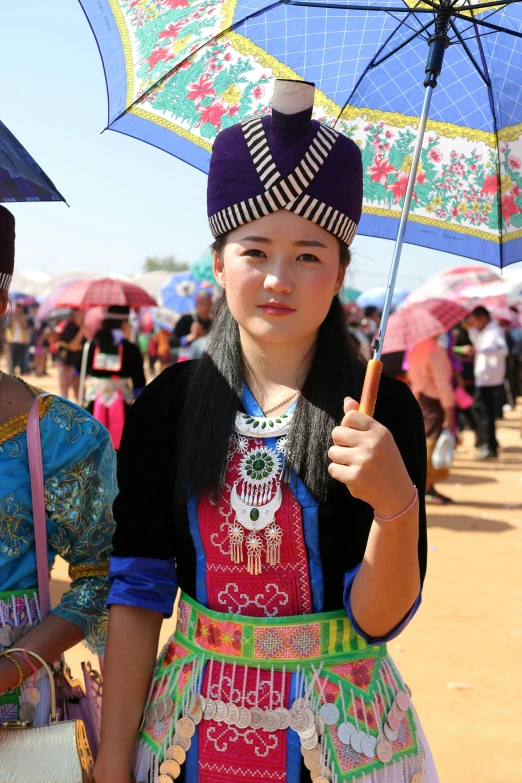 two asian women holding umbrellas in the wind