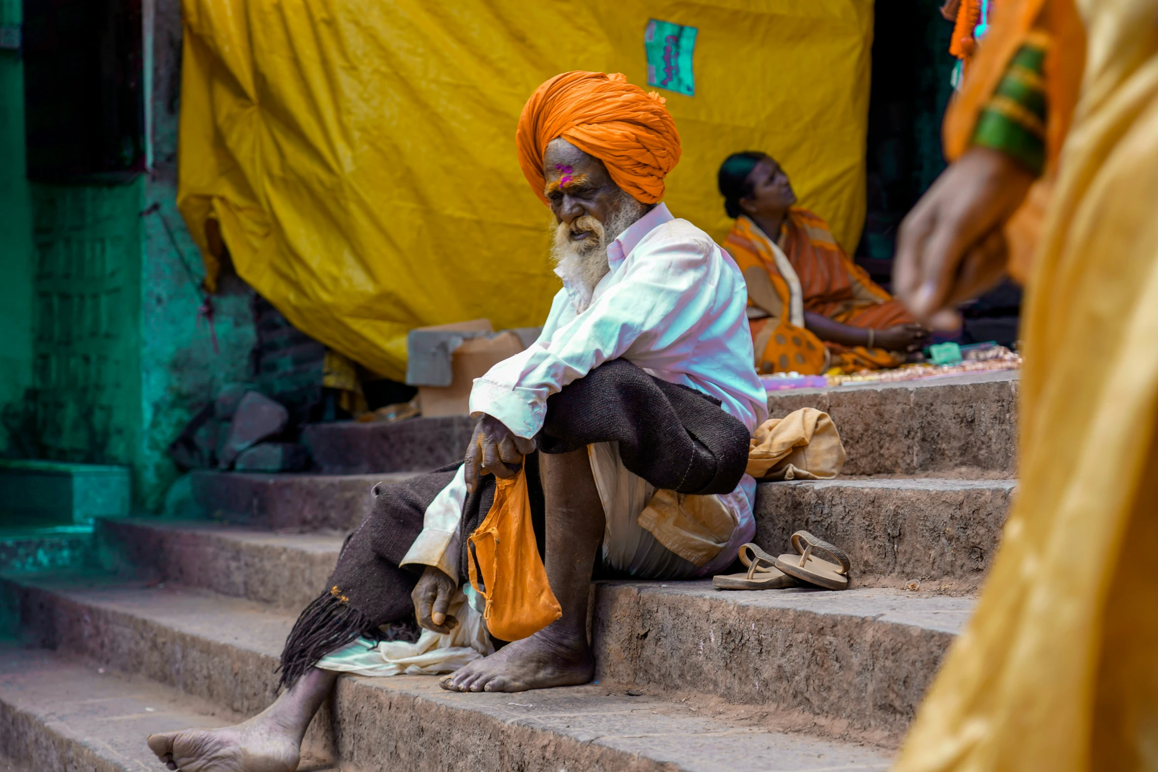 man sitting on steps in front of structure