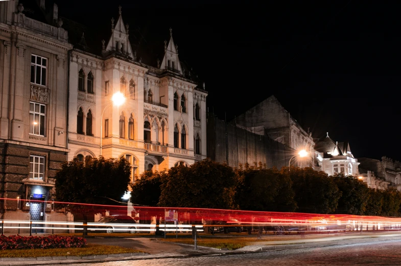 a night view of a city street and the front of the building