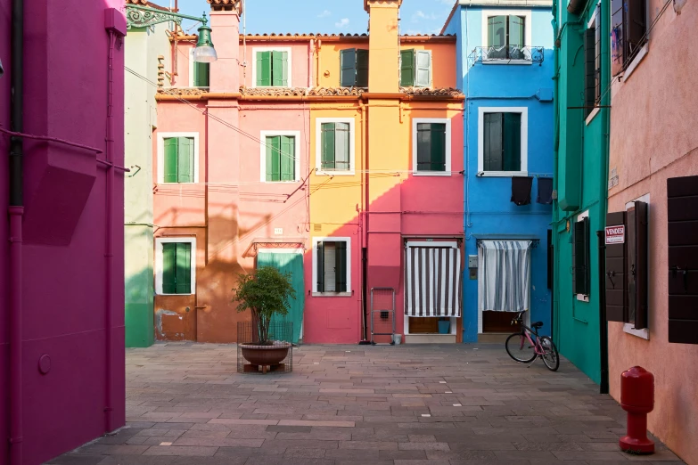 several multi - colored buildings lining a brick courtyard area