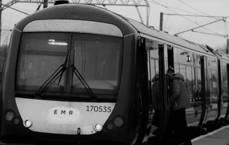 the side of a train with a man standing next to it