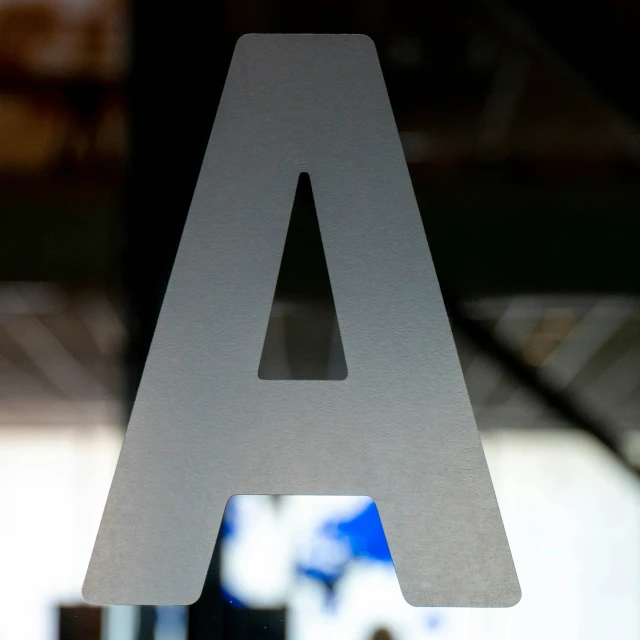 the letter a cut out of cardboard