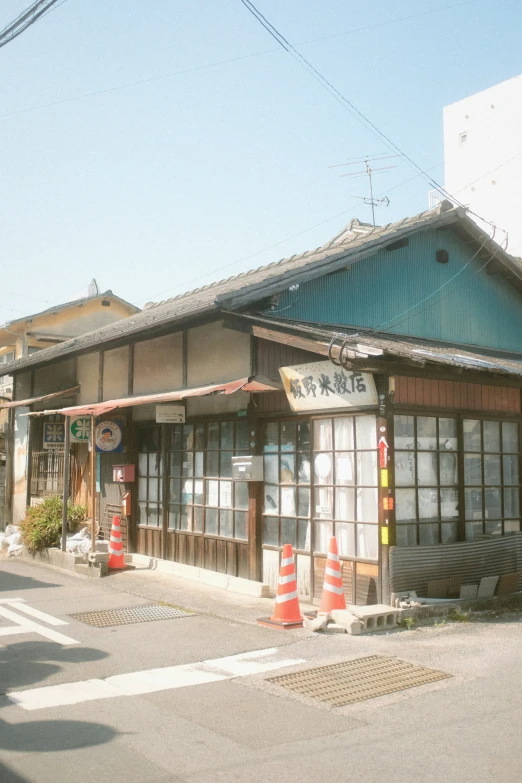 an asian restaurant on a side walk on a street