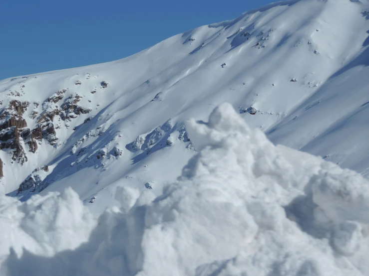 a man riding skis on top of snow covered ground