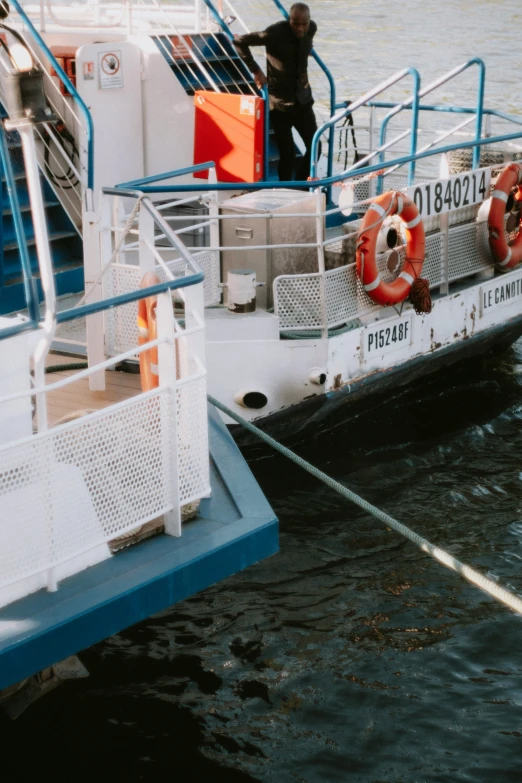 a boat with people on the deck that is being anchored