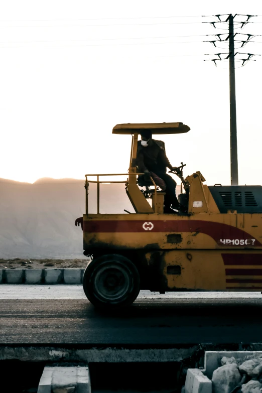 a large orange dump truck driving down the street