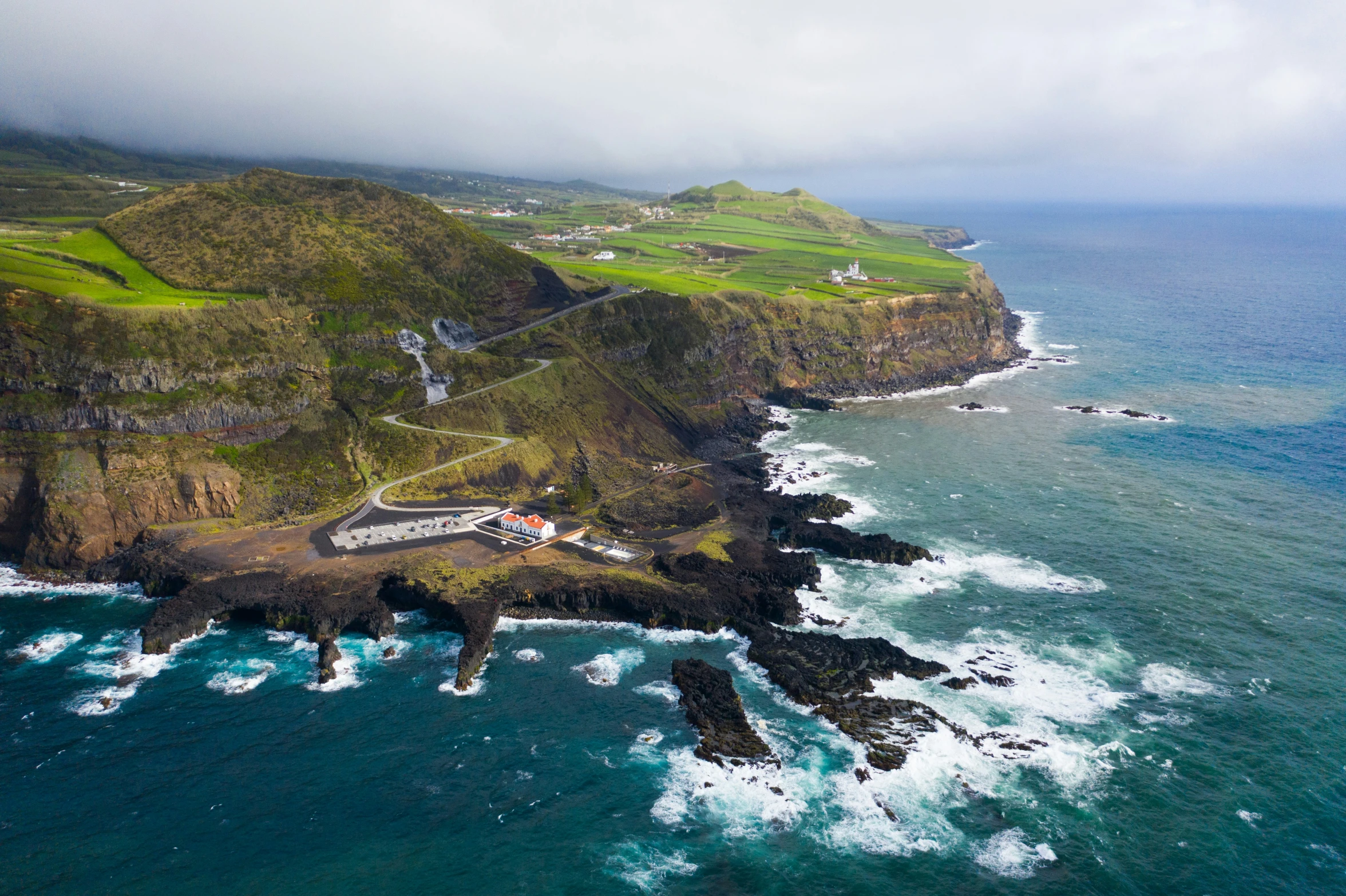 the green hills and coastline near an ocean