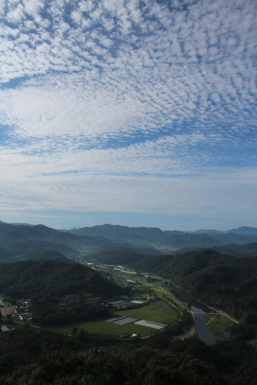 a scenic view of the countryside surrounded by mountains