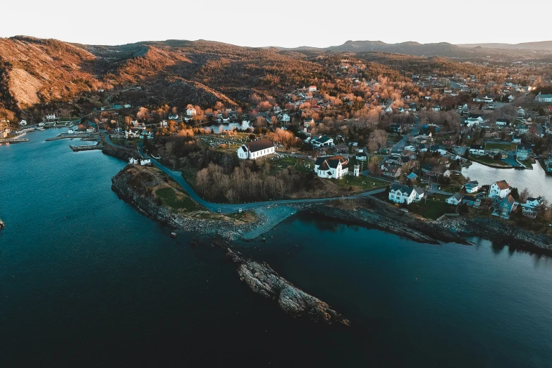 an aerial view of a town by the water