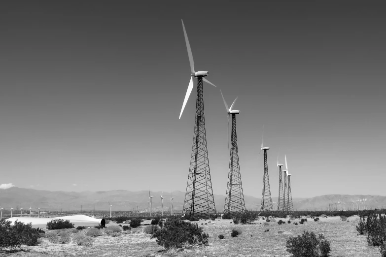 there are several wind turbines that can be seen in the desert