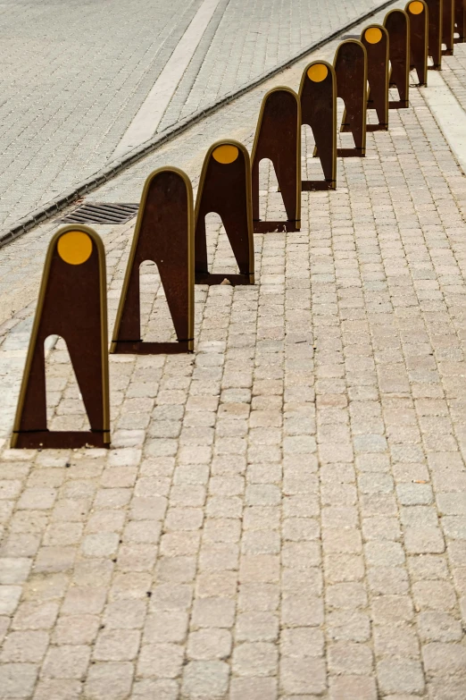 metal and wood railings on the sidewalk line a city street