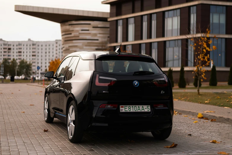 the back side of a bmw i8 car with it's door open