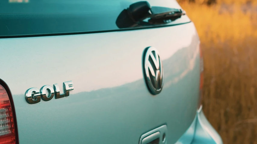 a golf car sits outside on the dirt