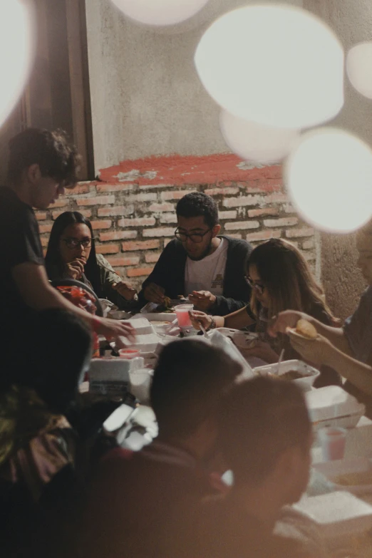 a group of people sitting around a table together