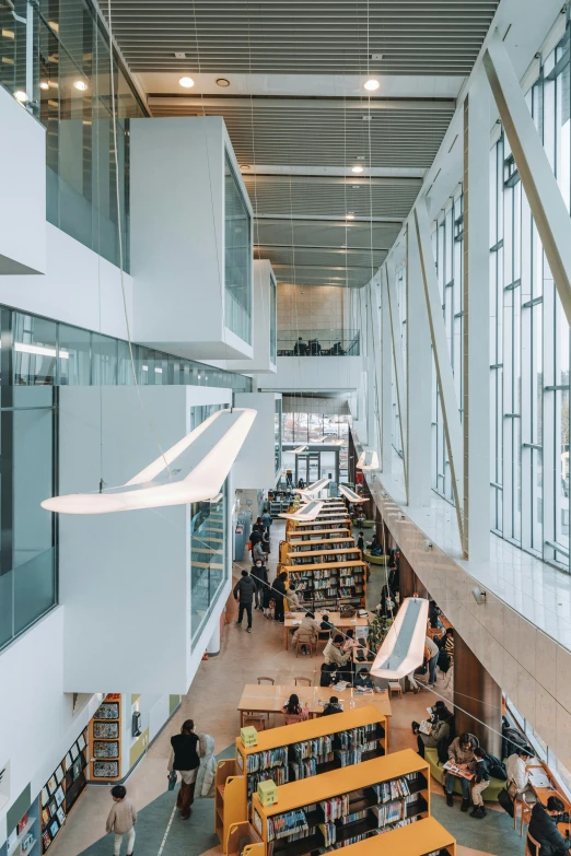 a long reading hall with a number of books on tables