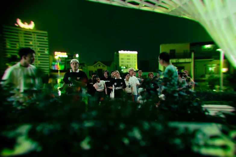 group of people in front of a large display with many buildings behind them