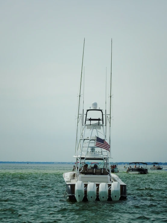 a boat sitting in the water with a flag attached to it