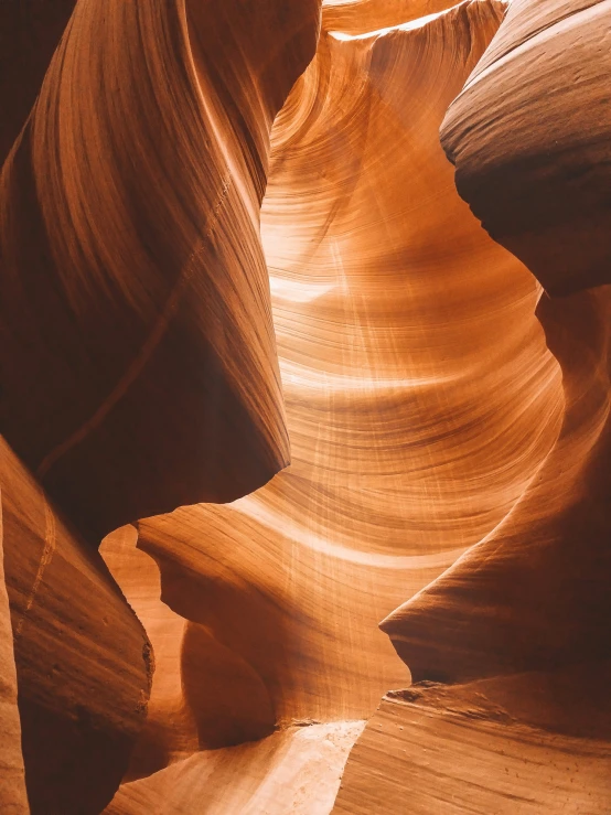 the sunlight shines on some rock that look like wave