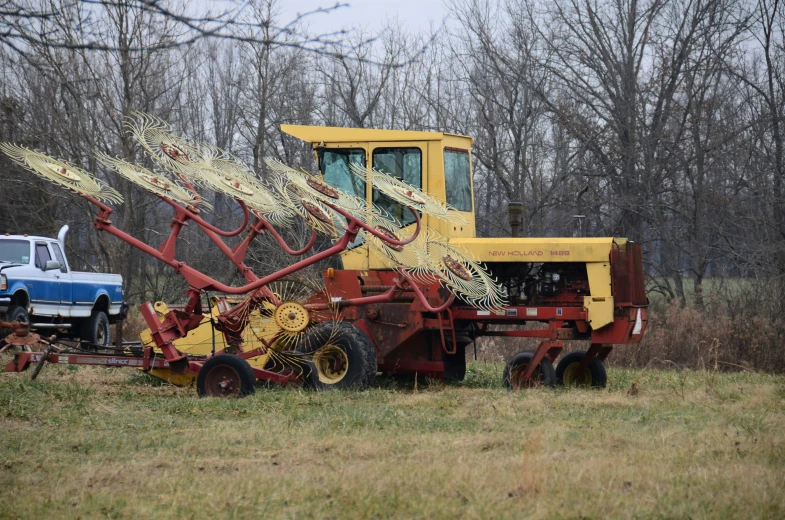 a man driving a yellow machine with a trailer on it