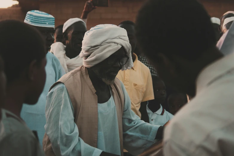 people standing around and other people near them in robes