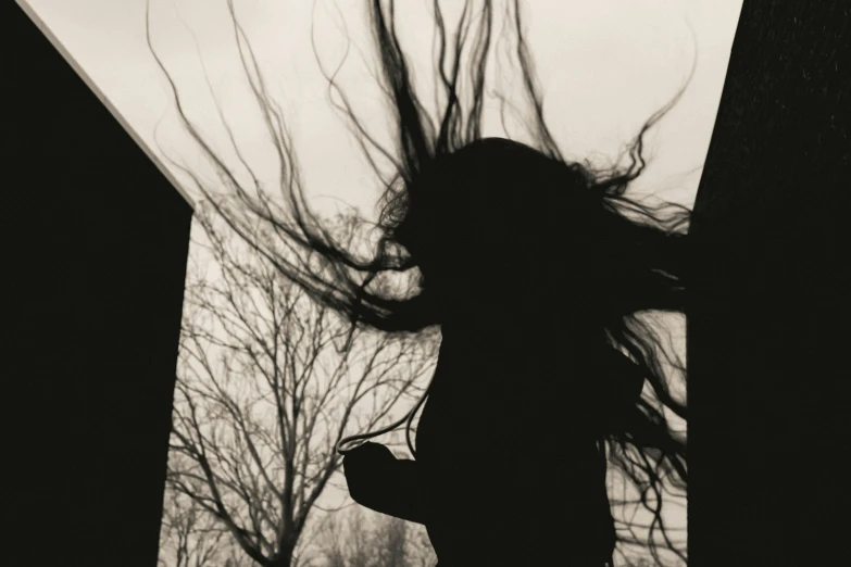 a woman with long hair in the air