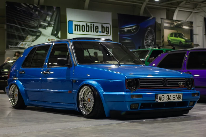 a blue volkswagen is shown parked on the street