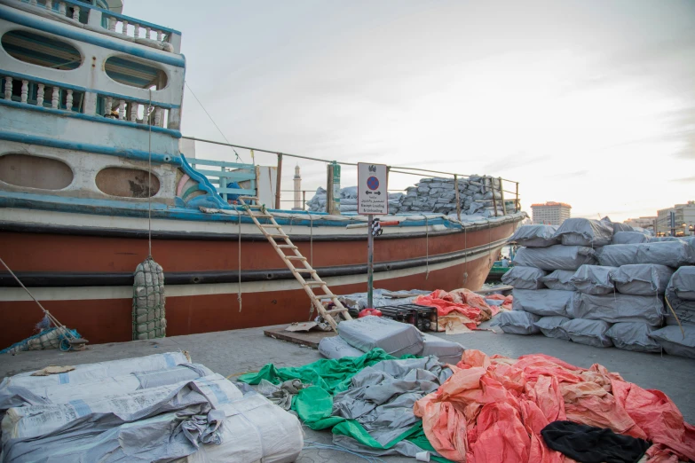 an old boat that is being remodeled with sand and bags