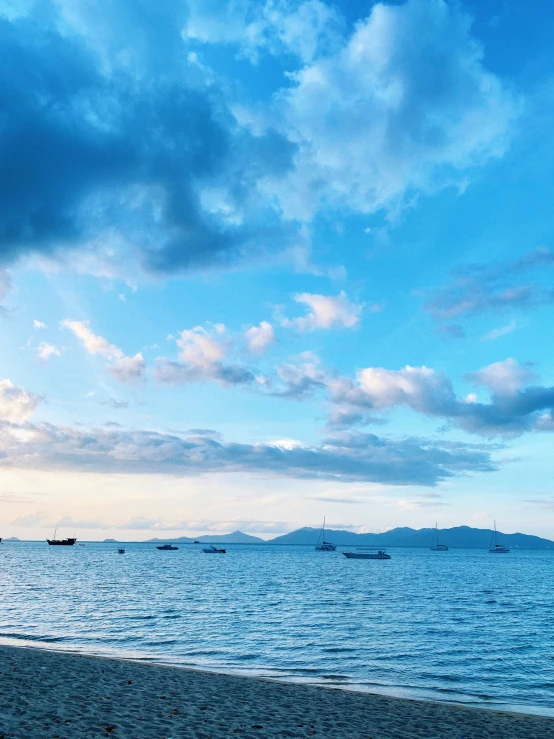 two people on the beach under an overcast sky