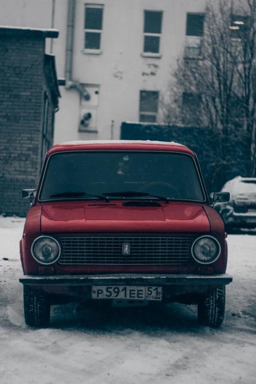 a red car parked on the street outside