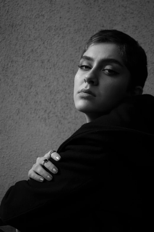 a woman in black sweaters with her arms crossed