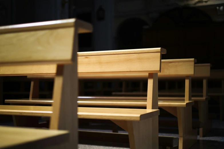 a set of wooden benches sitting in the middle of a building